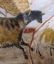 Ancient cave painting of horses in earthy tones from the Lascaux Cave in southwestern France