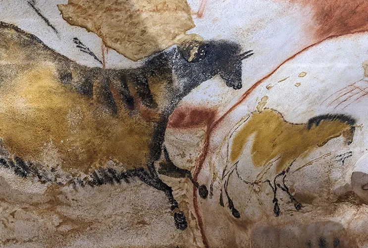 Ancient cave painting of horses in earthy tones from the Lascaux Cave in southwestern France
