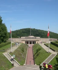 View of the Hartmannswillerkopf Memorial and Museum surrounded by greenery on a sunny day.