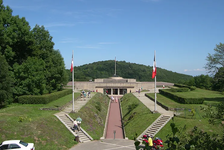 View of the Hartmannswillerkopf Memorial and Museum surrounded by greenery on a sunny day.