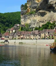 Traditional stone houses of La Roque-Gageac built into cliffs along the Dordogne River in southwestern France
