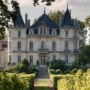 Majestic château surrounded by vineyards in the Médoc wine region, Bordeaux, under warm summer light
